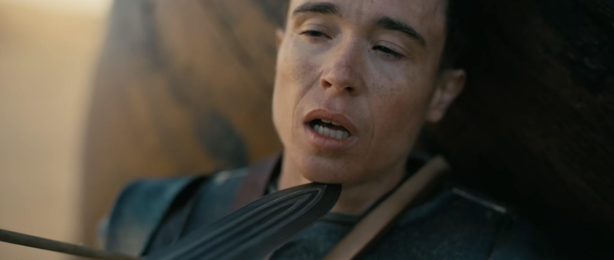Elliot Page as Sinon held at knifepoint in Christopher Nolan’s The Odyssey (2026).